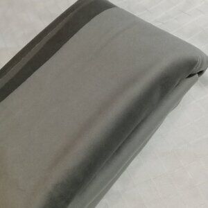 Large, end-of-roll piece of green fabric on both sides (one light and one dark)